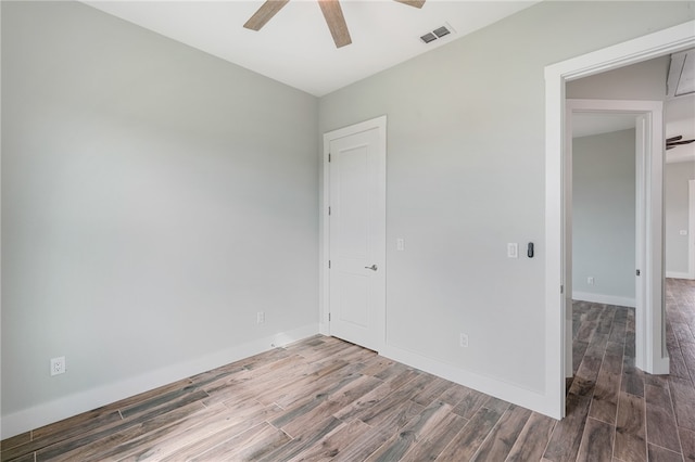 empty room with hardwood / wood-style floors and ceiling fan