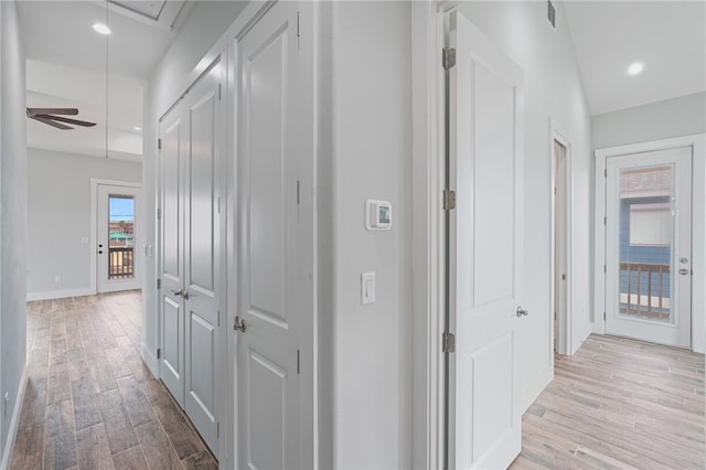 corridor with light hardwood / wood-style floors