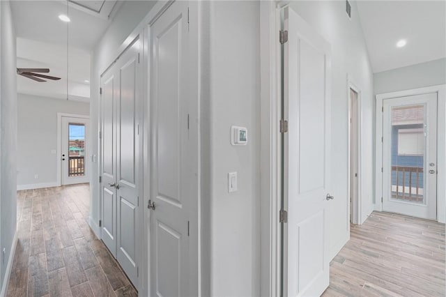 1007 S Live Oak St, Rockport, TX 78382 - corridor with attic access, light wood finished floors, and baseboards
