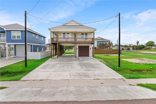 1007 S Live Oak St, Rockport, TX 78382 - raised beach house with an attached garage, driveway, a carport, and a shingled roof