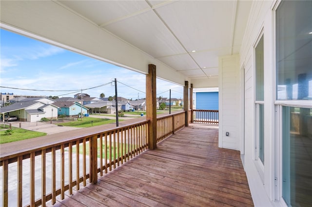 wooden deck featuring a garage and covered porch