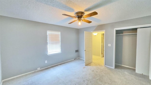134 W C Ave, Kingsville, TX 78363 - unfurnished bedroom with a textured ceiling, a closet, carpet floors, and a ceiling fan