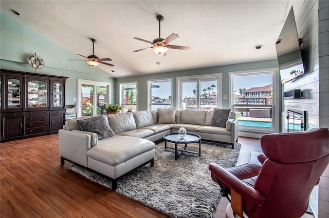 living room with high vaulted ceiling, hardwood / wood-style floors, ceiling fan, and a fireplace