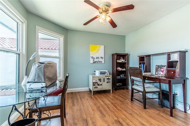 office with wood-type flooring and ceiling fan