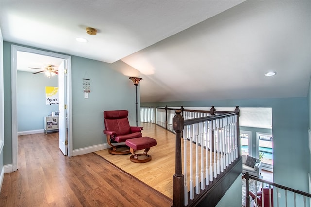 stairway with vaulted ceiling, hardwood / wood-style flooring, and ceiling fan