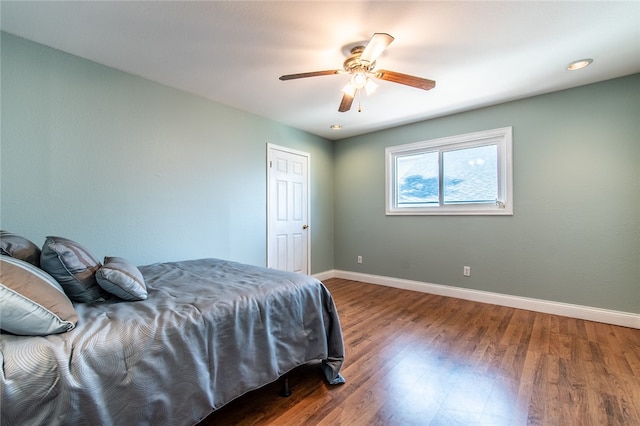 bedroom featuring dark hardwood / wood-style flooring and ceiling fan