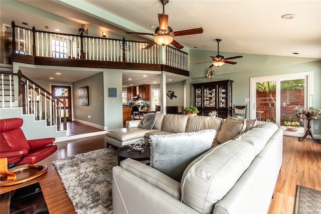 living room featuring ceiling fan, light hardwood / wood-style flooring, and high vaulted ceiling