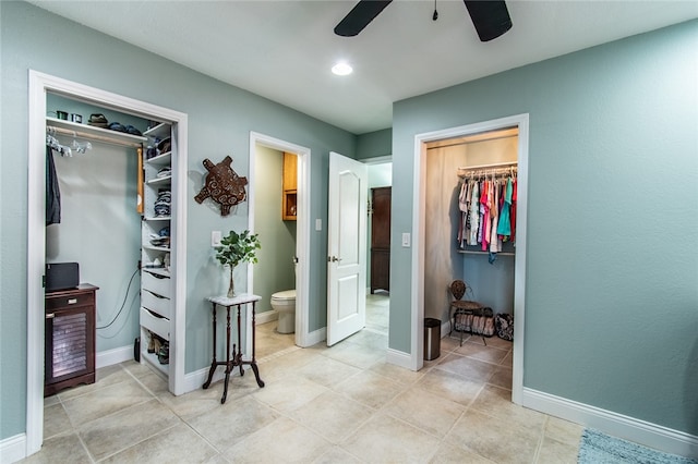 bedroom featuring connected bathroom, a closet, light tile patterned floors, and ceiling fan