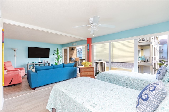 bedroom with ceiling fan and hardwood / wood-style flooring