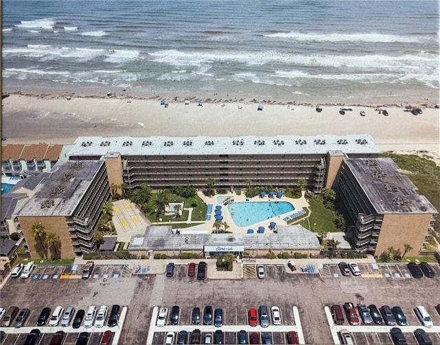 bird's eye view featuring a water view and a beach view