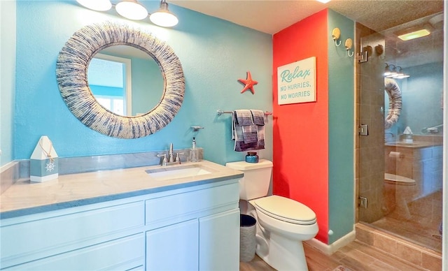 bathroom featuring hardwood / wood-style floors, toilet, an enclosed shower, and vanity