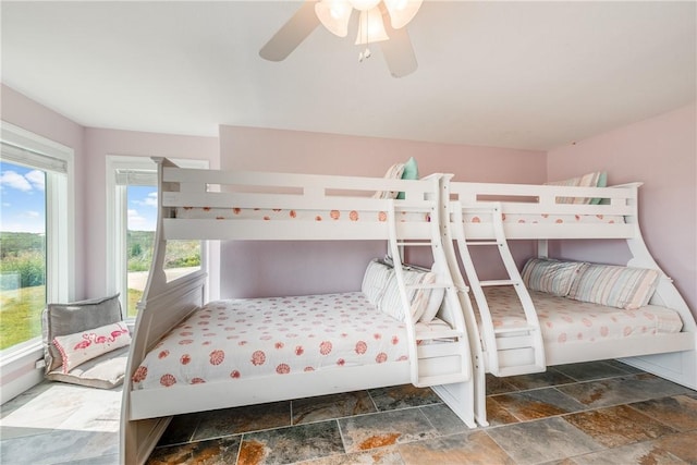800 Beach Access Road 1a 804, Port Aransas, TX 78373 - bedroom with stone tile floors, multiple windows, and a ceiling fan