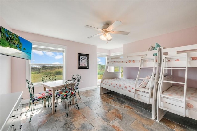 800 Beach Access Road 1a 804, Port Aransas, TX 78373 - bedroom with stone tile flooring, baseboards, and ceiling fan
