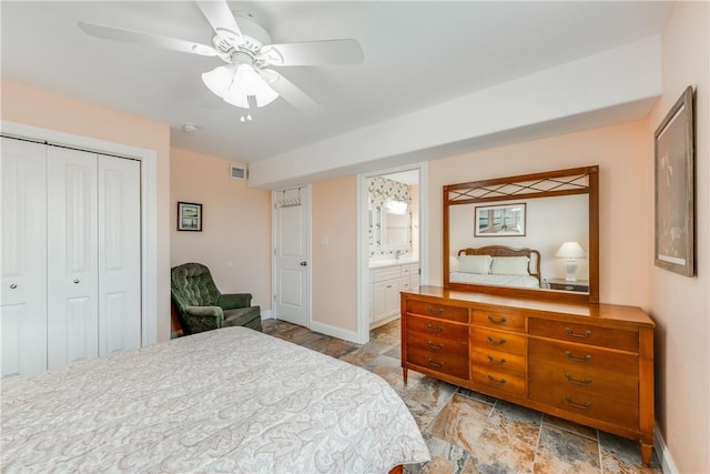 800 Beach Access Road 1a 804, Port Aransas, TX 78373 - bedroom with baseboards, stone tile floors, a closet, and a ceiling fan