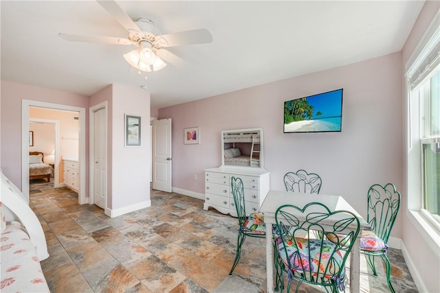 800 Beach Access Road 1a 804, Port Aransas, TX 78373 - dining area featuring light stone finish flooring, baseboards, and a ceiling fan