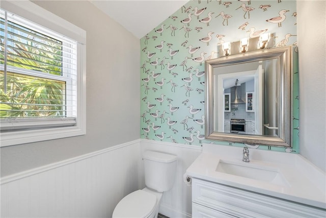 800 Beach Access Road 1a 804, Port Aransas, TX 78373 - half bath with a wainscoted wall, lofted ceiling, toilet, and vanity