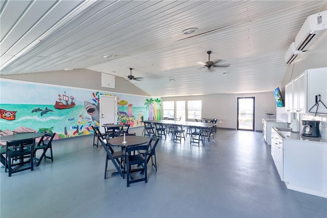 800 Beach Access Road 1a 804, Port Aransas, TX 78373 - dining area with finished concrete floors, vaulted ceiling, an AC wall unit, and a ceiling fan