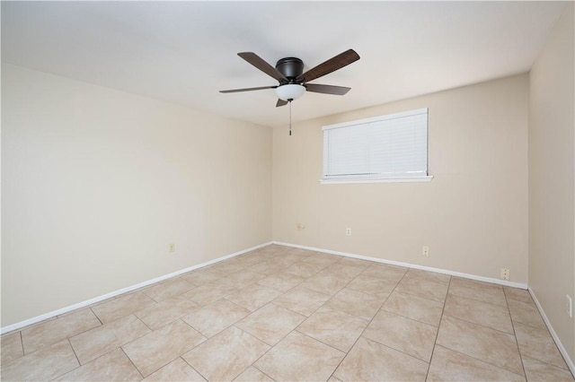 unfurnished room featuring ceiling fan, light tile patterned floors, and baseboards