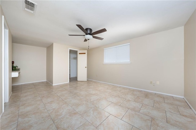 unfurnished room featuring a ceiling fan, visible vents, baseboards, and light tile patterned floors