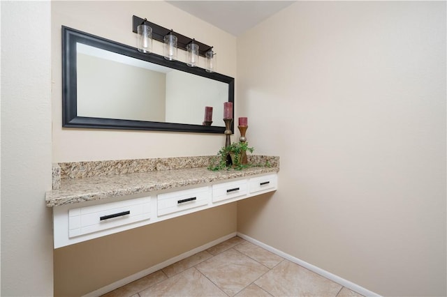 bathroom with tile patterned flooring and baseboards