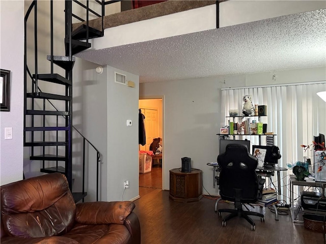 office space with hardwood / wood-style floors and a textured ceiling