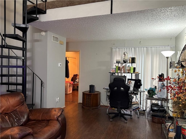 home office with hardwood / wood-style flooring and a textured ceiling