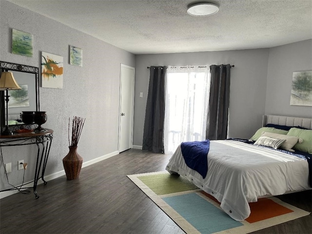 bedroom featuring dark hardwood / wood-style flooring and a textured ceiling