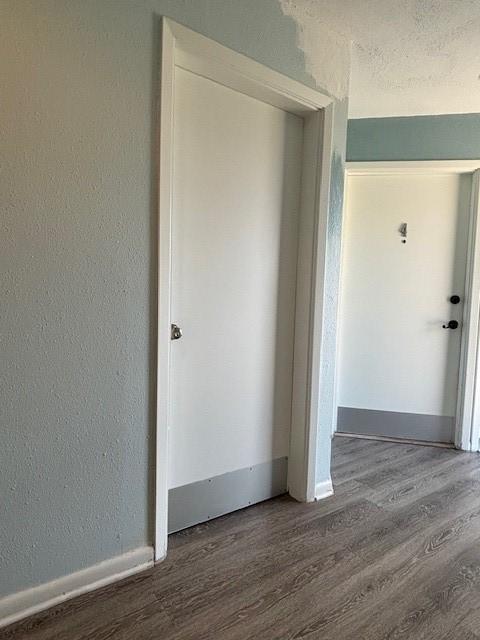 spare room with wood-type flooring