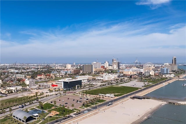 property's view of city featuring a water view and a beach view