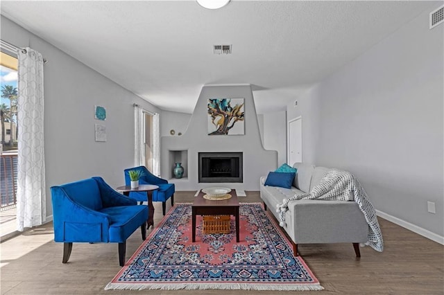 living room featuring a wealth of natural light and hardwood / wood-style flooring