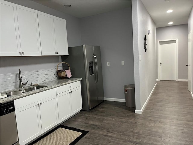 kitchen with dark hardwood / wood-style floors, white cabinetry, sink, and appliances with stainless steel finishes