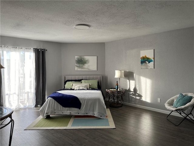 bedroom with a textured ceiling and hardwood / wood-style flooring