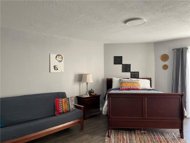 bedroom with a textured ceiling and hardwood / wood-style flooring