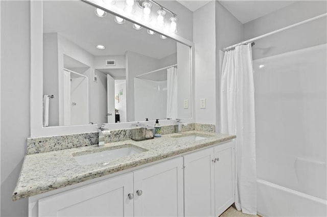 bathroom with shower / bath combo and vanity