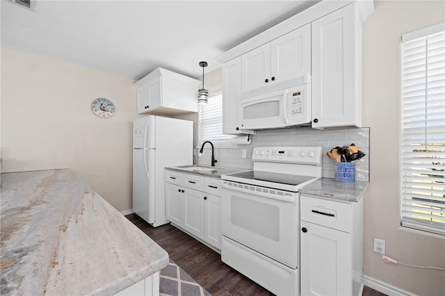 kitchen with white cabinetry, backsplash, white appliances, and decorative light fixtures