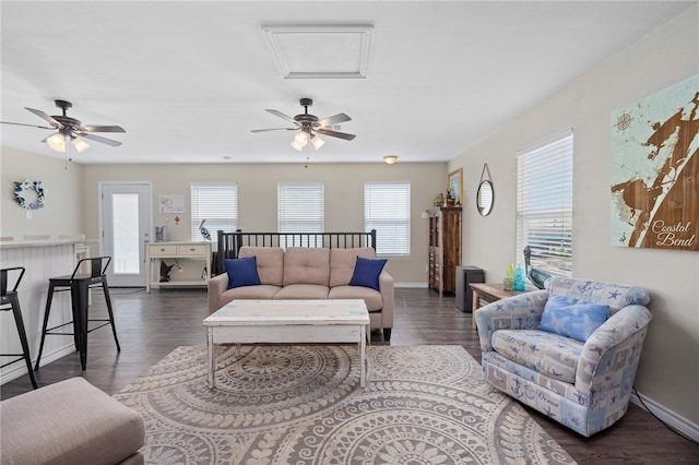 living room featuring a wealth of natural light, dark hardwood / wood-style floors, and ceiling fan