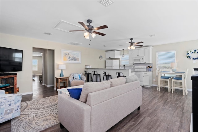 living room with ceiling fan, sink, and dark hardwood / wood-style flooring