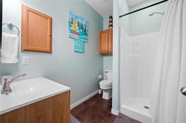 2001 S Doughty St, Rockport, TX 78382 - full bathroom featuring a shower stall, finished concrete flooring, toilet, baseboards, and vanity