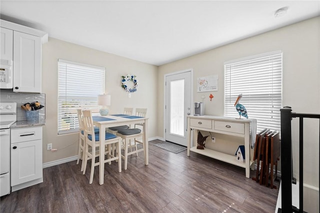 2001 S Doughty St, Rockport, TX 78382 - dining area with dark wood-style flooring and baseboards