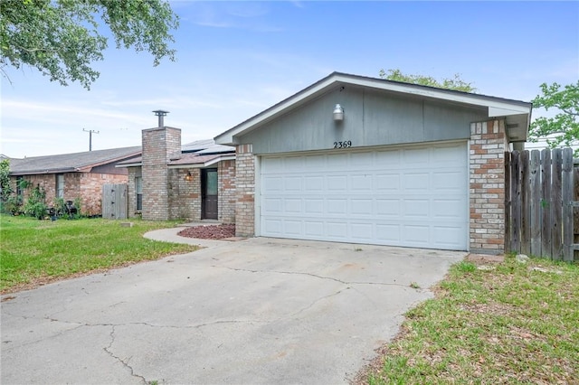 ranch-style house with a garage and a front lawn