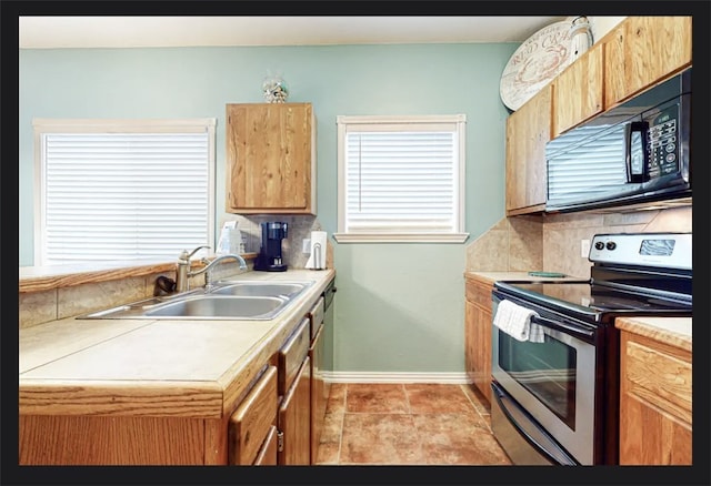 kitchen featuring tasteful backsplash, sink, stainless steel range with electric cooktop, and light tile patterned flooring