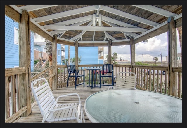 sunroom featuring vaulted ceiling with beams