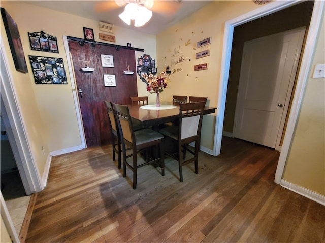 dining area featuring dark hardwood / wood-style flooring and ceiling fan