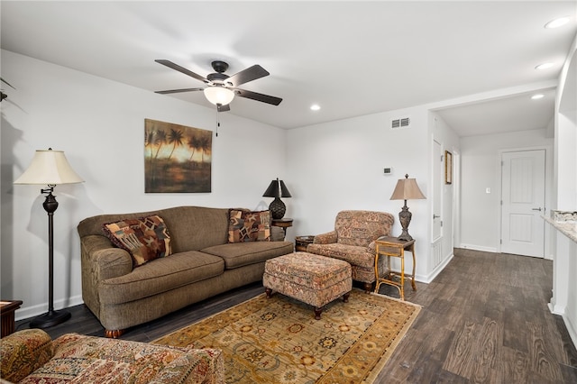 living room with dark wood-type flooring and ceiling fan