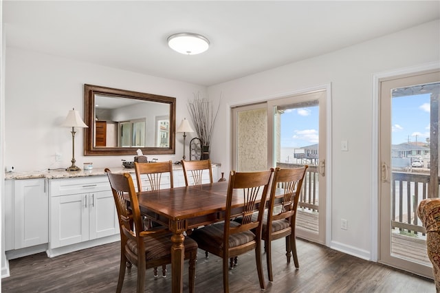 dining space with dark hardwood / wood-style floors