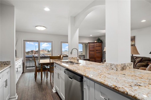 kitchen featuring dishwasher, dark hardwood / wood-style flooring, white cabinetry, and sink