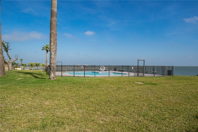 view of yard with a water view and a community pool