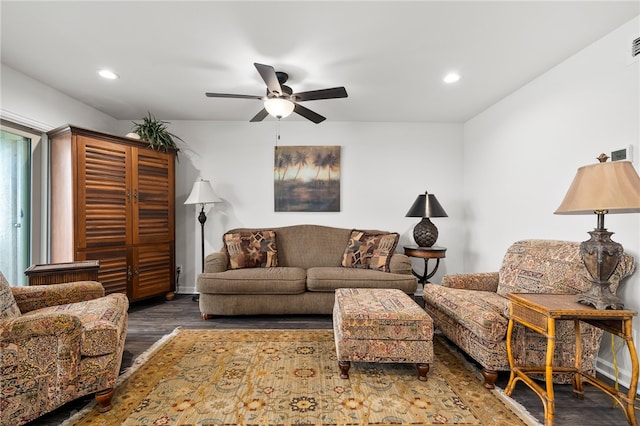 living room with dark wood-type flooring and ceiling fan