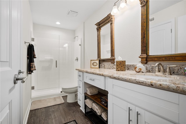 bathroom with walk in shower, vanity, toilet, and hardwood / wood-style flooring