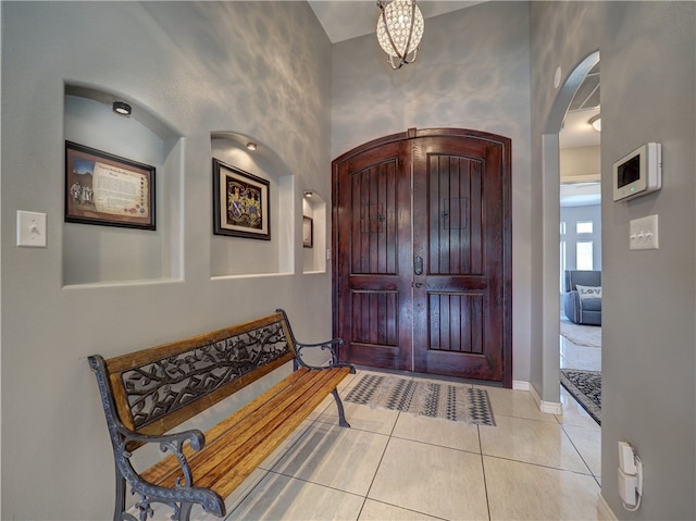 entrance foyer featuring a notable chandelier and light tile patterned flooring